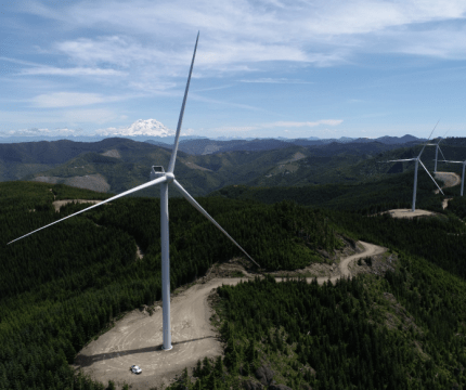 Aerial shot of a row of wind turbines at PSE's Skookumchuck wind facility high in the Cascade foothills