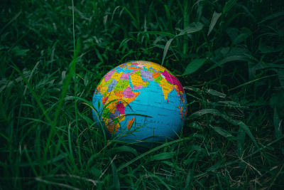 A small globe lying in grass