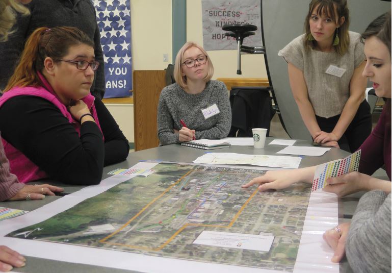 The transportation project team listens to Arlington residents as they point at a city map