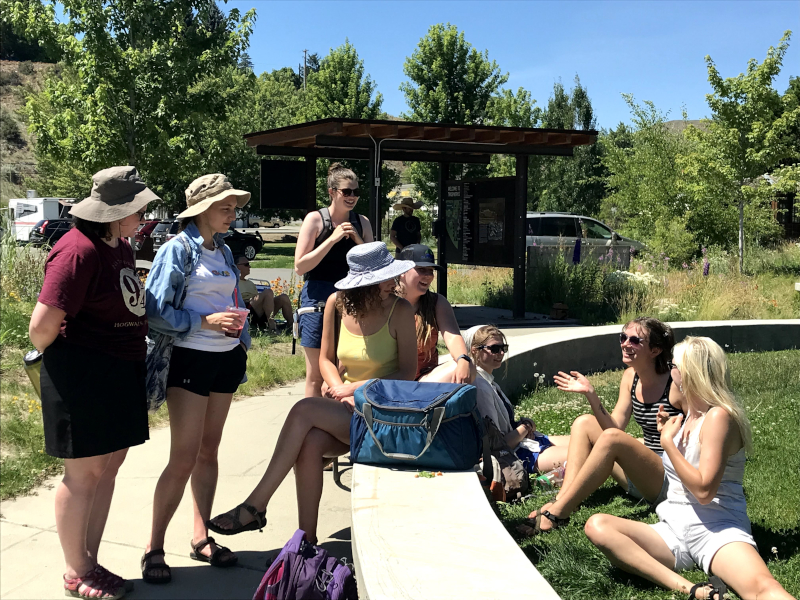 A group of students hang out in a green space outside TwispWorks in the Methow Valley
