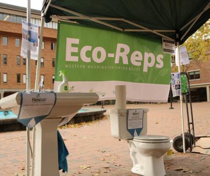 An EcoReps booth in Red Square with a toilet and sink set up to encourage reducing water waste.