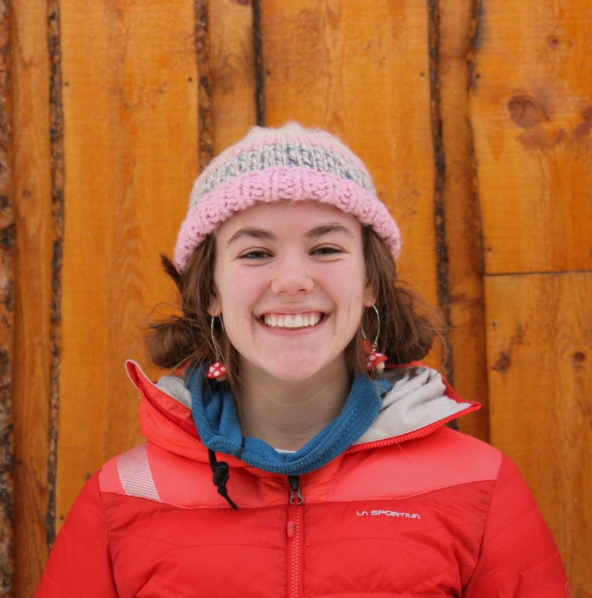 Brunette girl wearing pink hat and red jacket