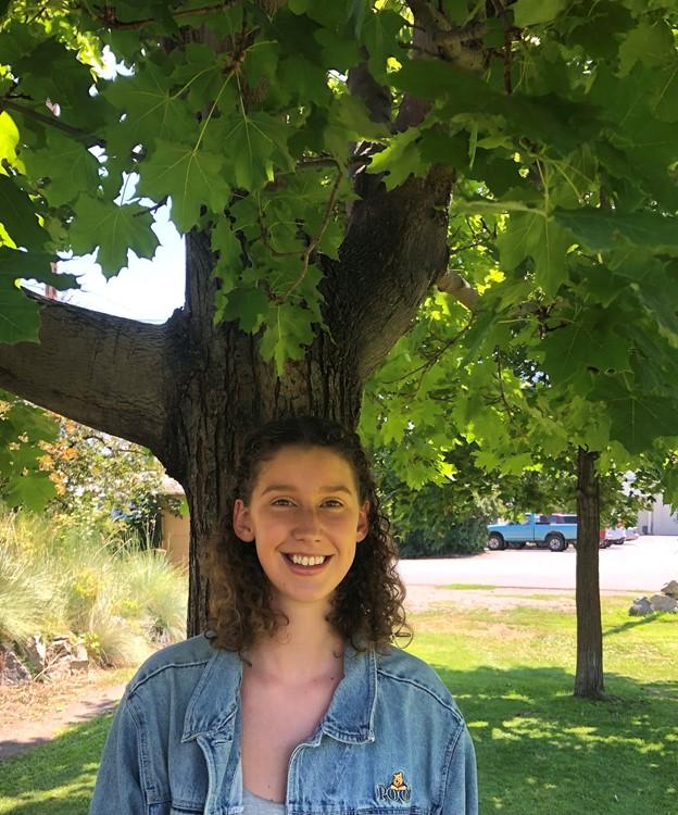 Libby Taylor-Manning stands in front of a tree