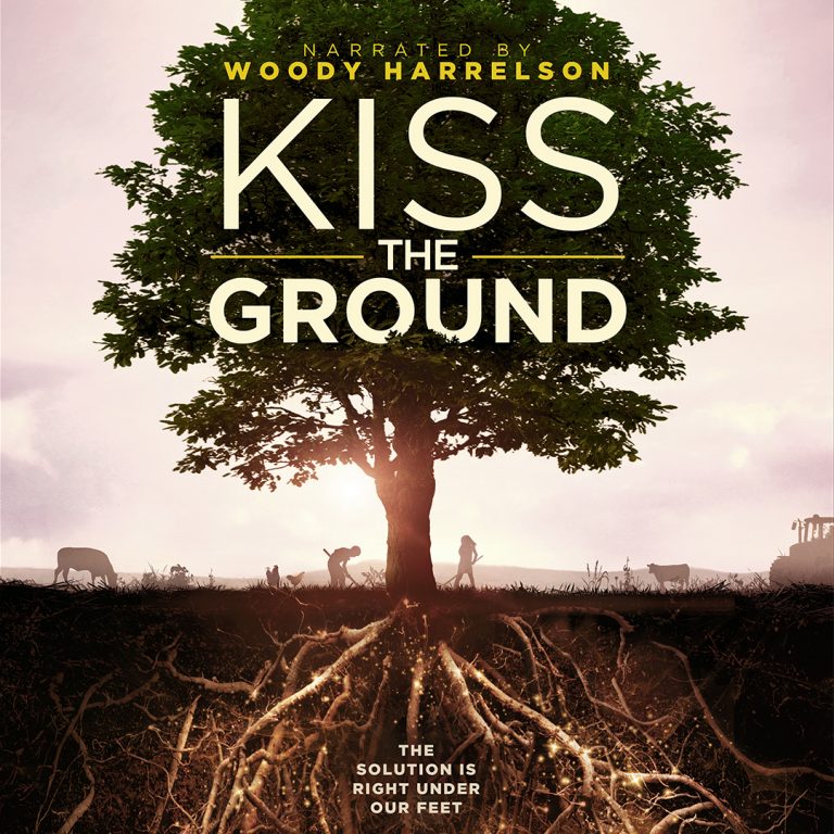 An image of a tree with roots visible under the ground. The background of the image has animals grazing and farmer working on the field. The text on the top part of the image says "Narrated by Woody Harrelson Kiss The ground" and the bottom parts says "The solution is right under our feet".